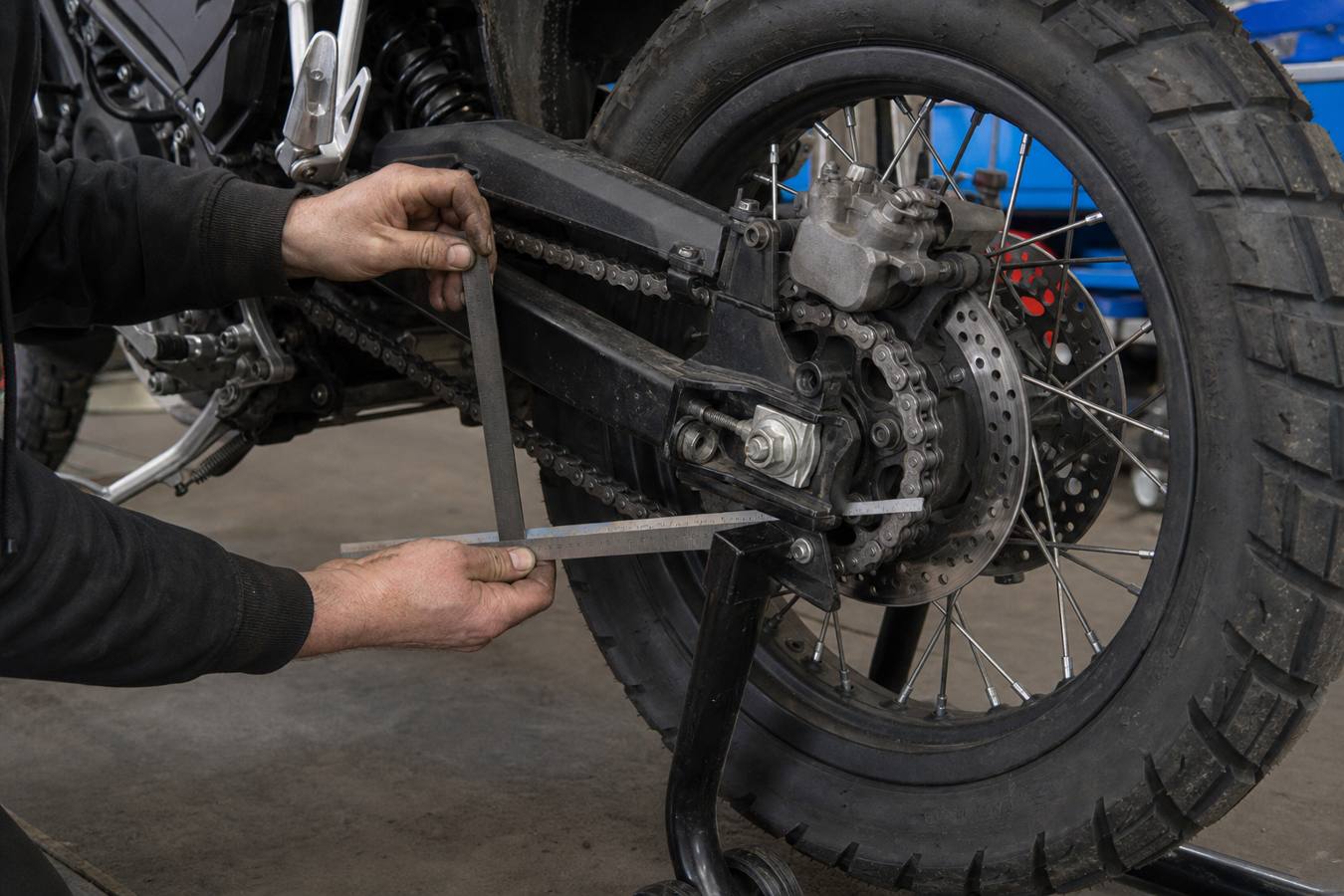 Checking chain slack and rear brake condition on a 125 adventure motorcycle